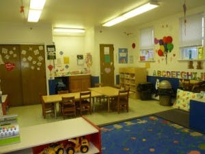 Classroom with tables, chairs, and colorful decorations