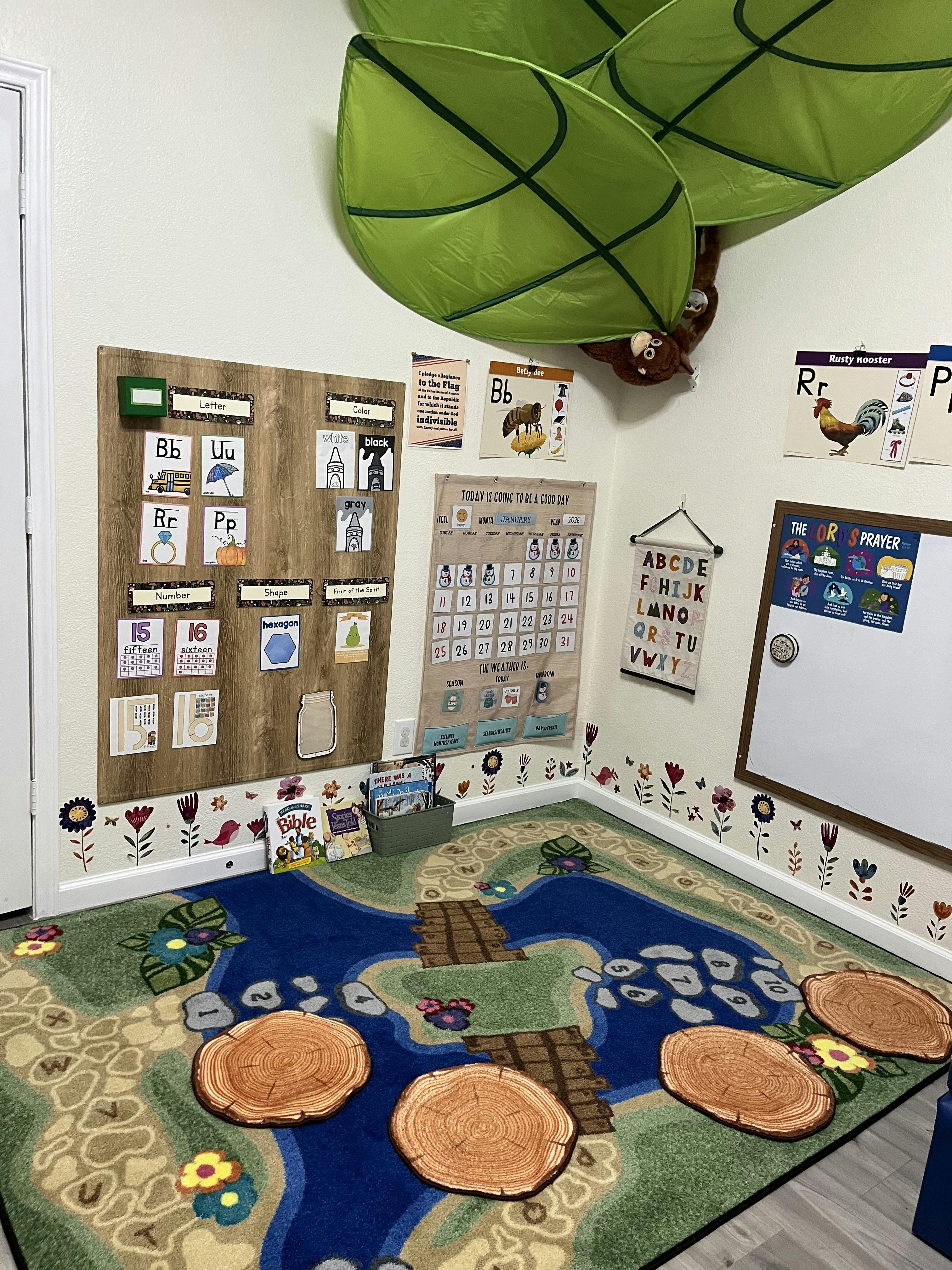 Classroom with alphabet charts, calendar, and a nature-themed rug