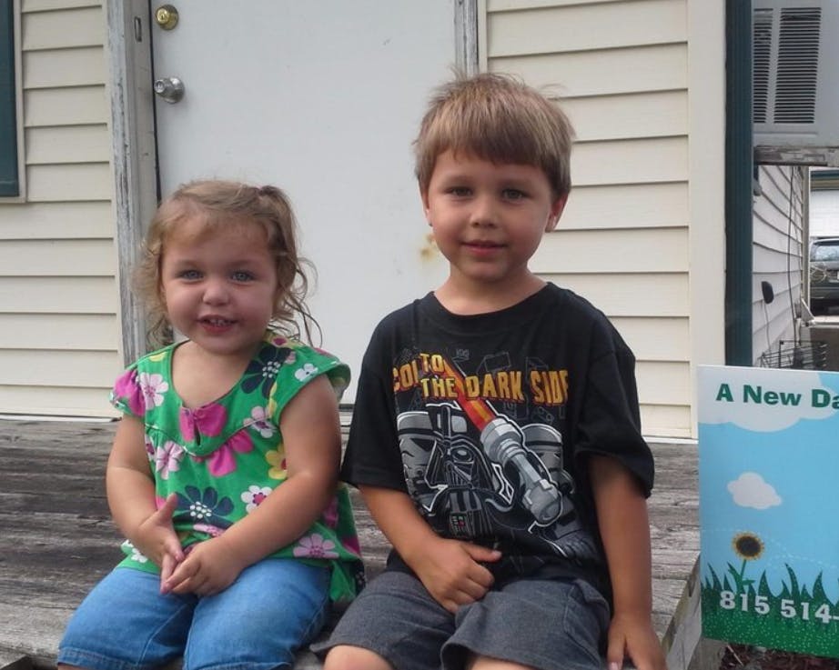 Two children sitting side by side