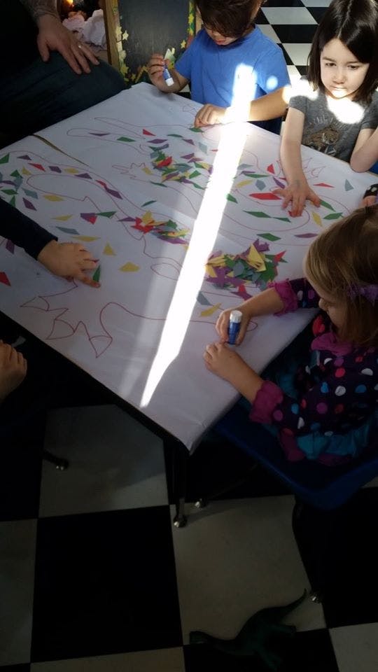 Children doing an art project at a table