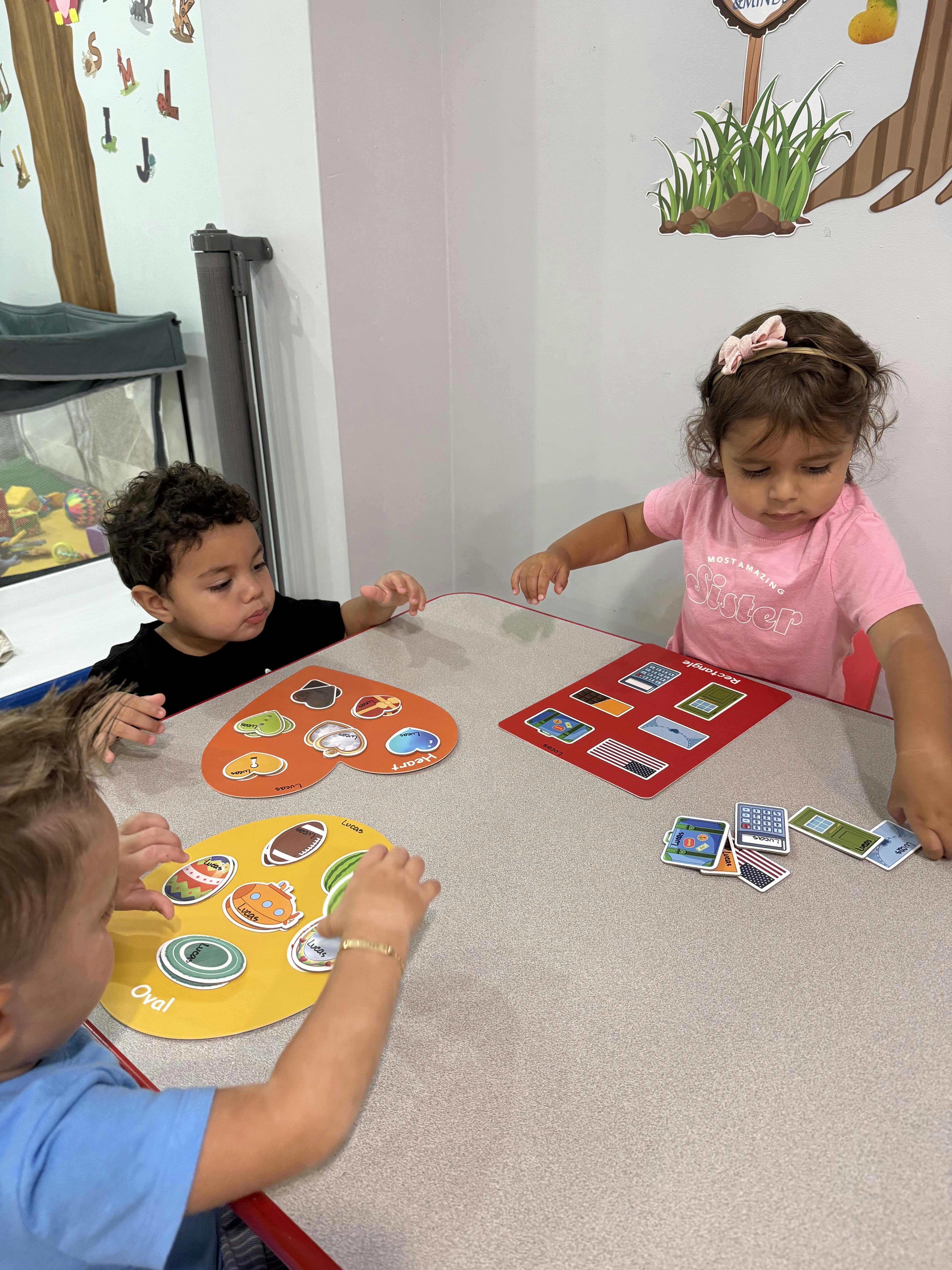 Three children playing a matching game at a table