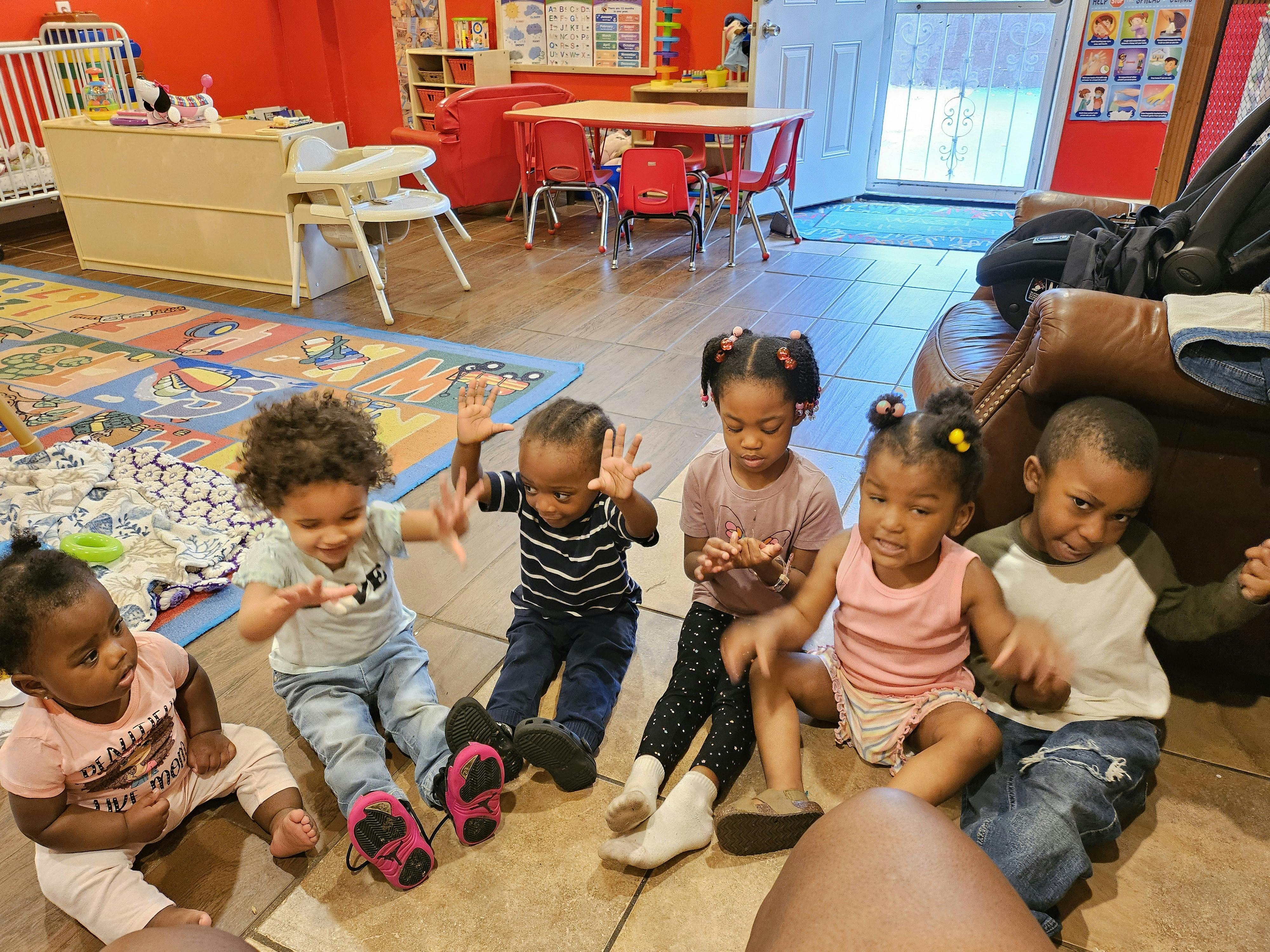 Group of children sitting on the floor in a classroom