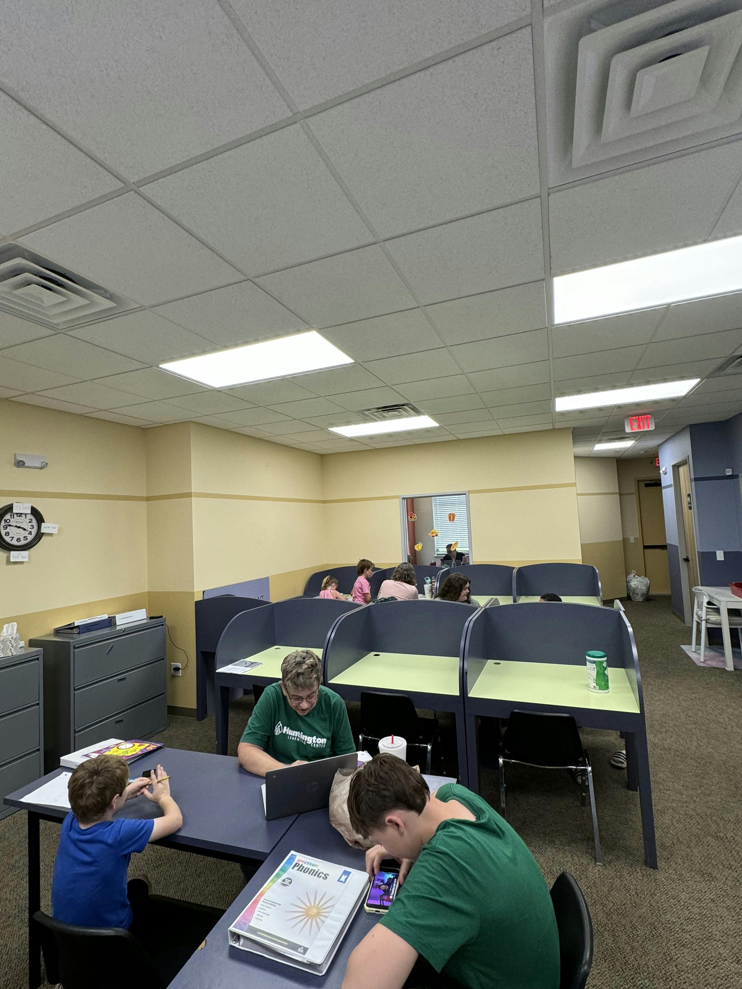 People studying at individual desks in a classroom setting