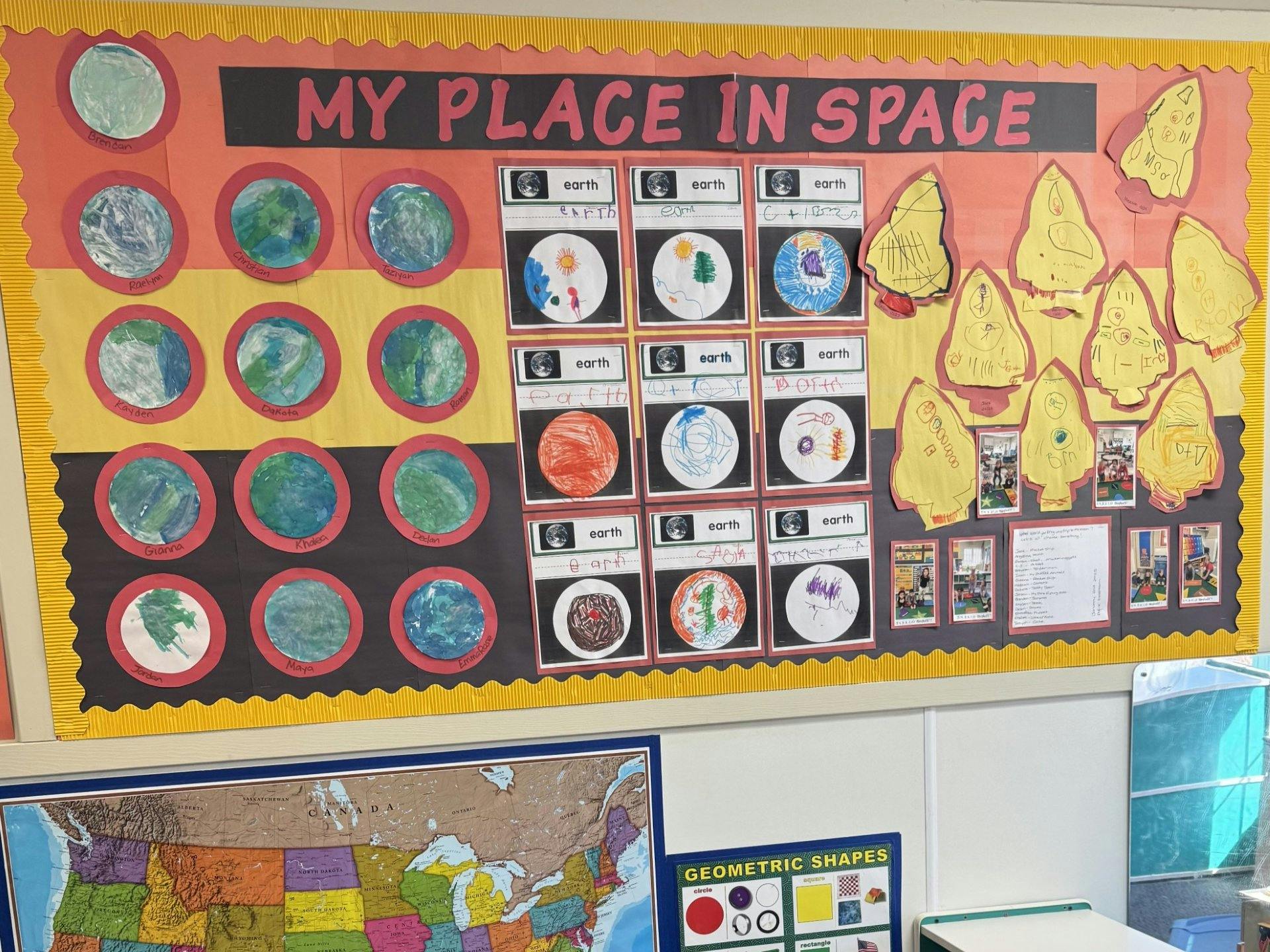 Classroom bulletin board with "My Place in Space" theme, featuring child drawings