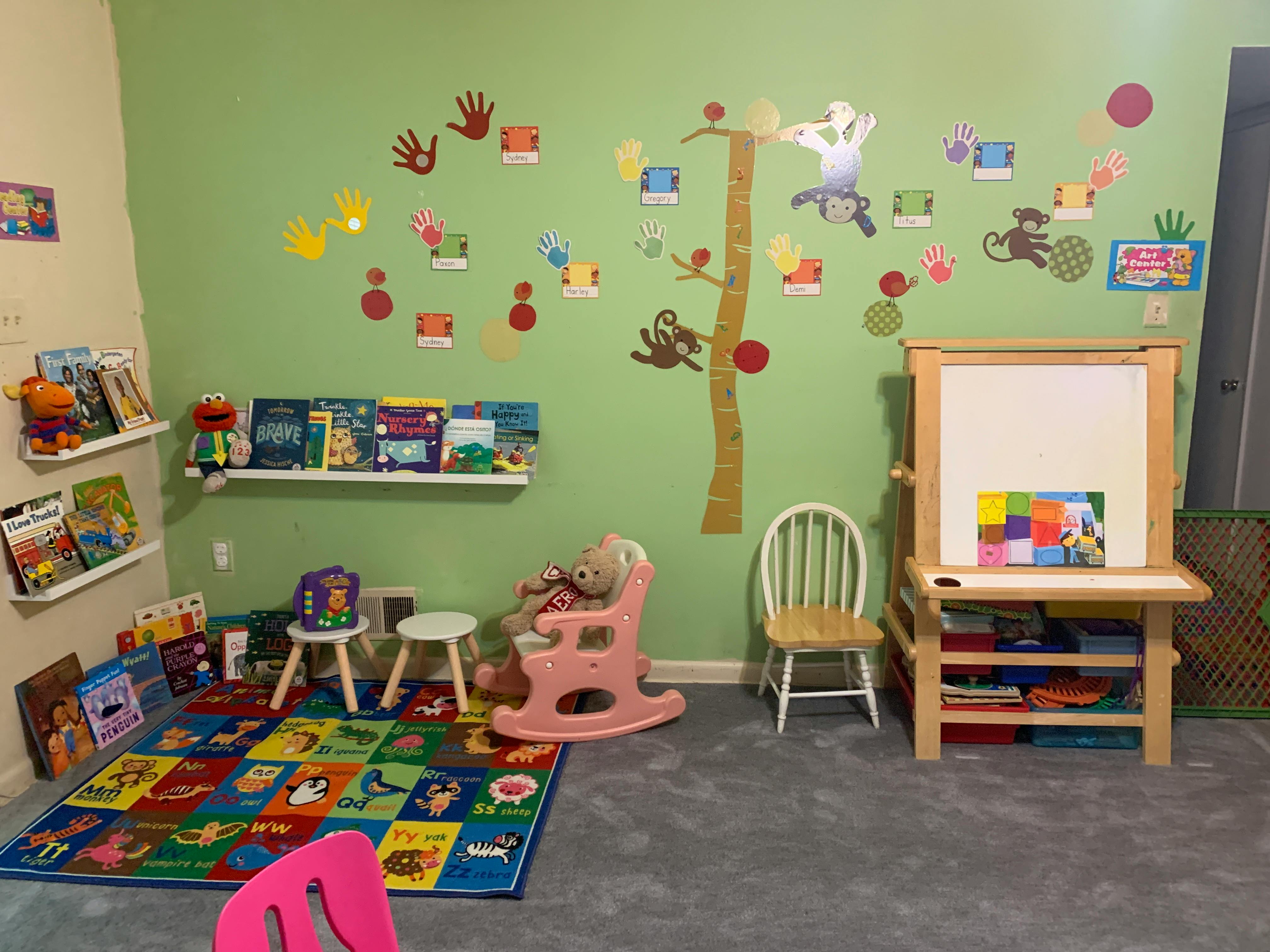 Children's play area with books, toys, and wall decorations