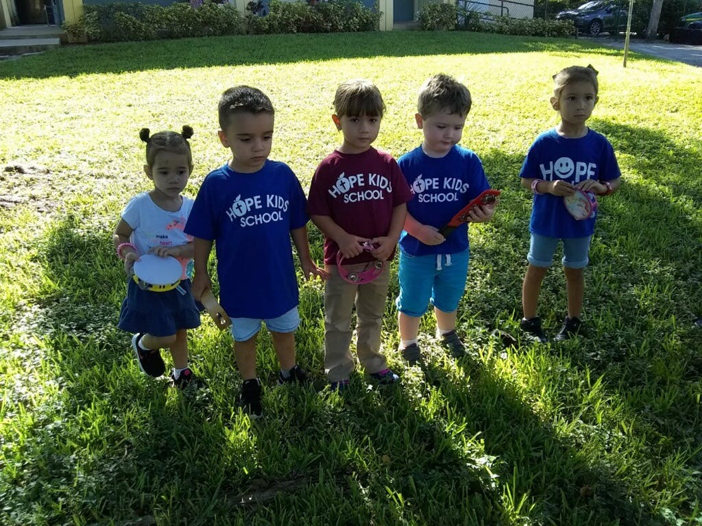 Five children standing on grass