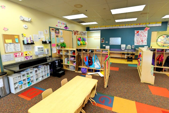 Classroom with tables, cubbies, and learning materials