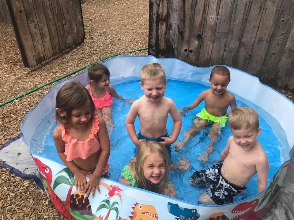 Multiple children in a small inflatable pool