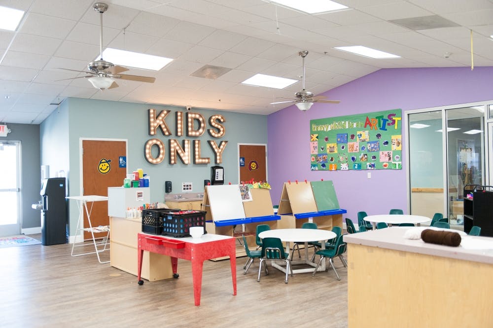 Kids Only sign in a brightly lit room with small tables and chairs