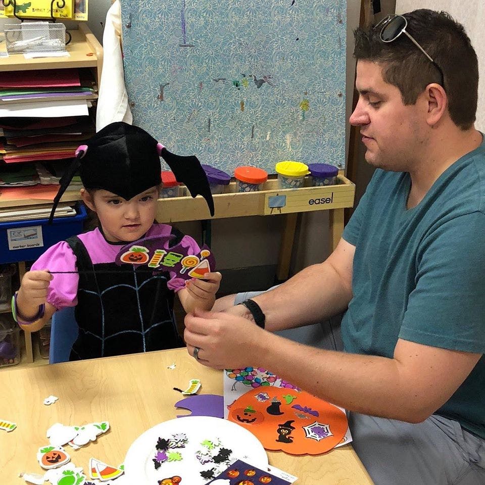 Adult and child crafting together at a table