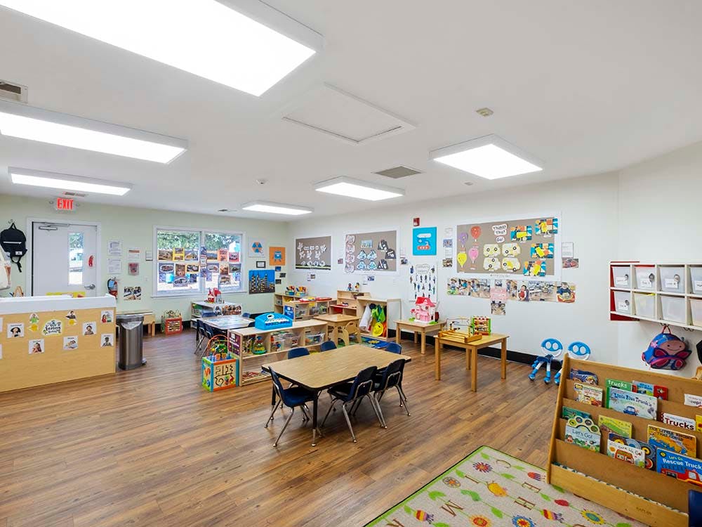 Classroom with tables, chairs, and colorful decorations on the walls