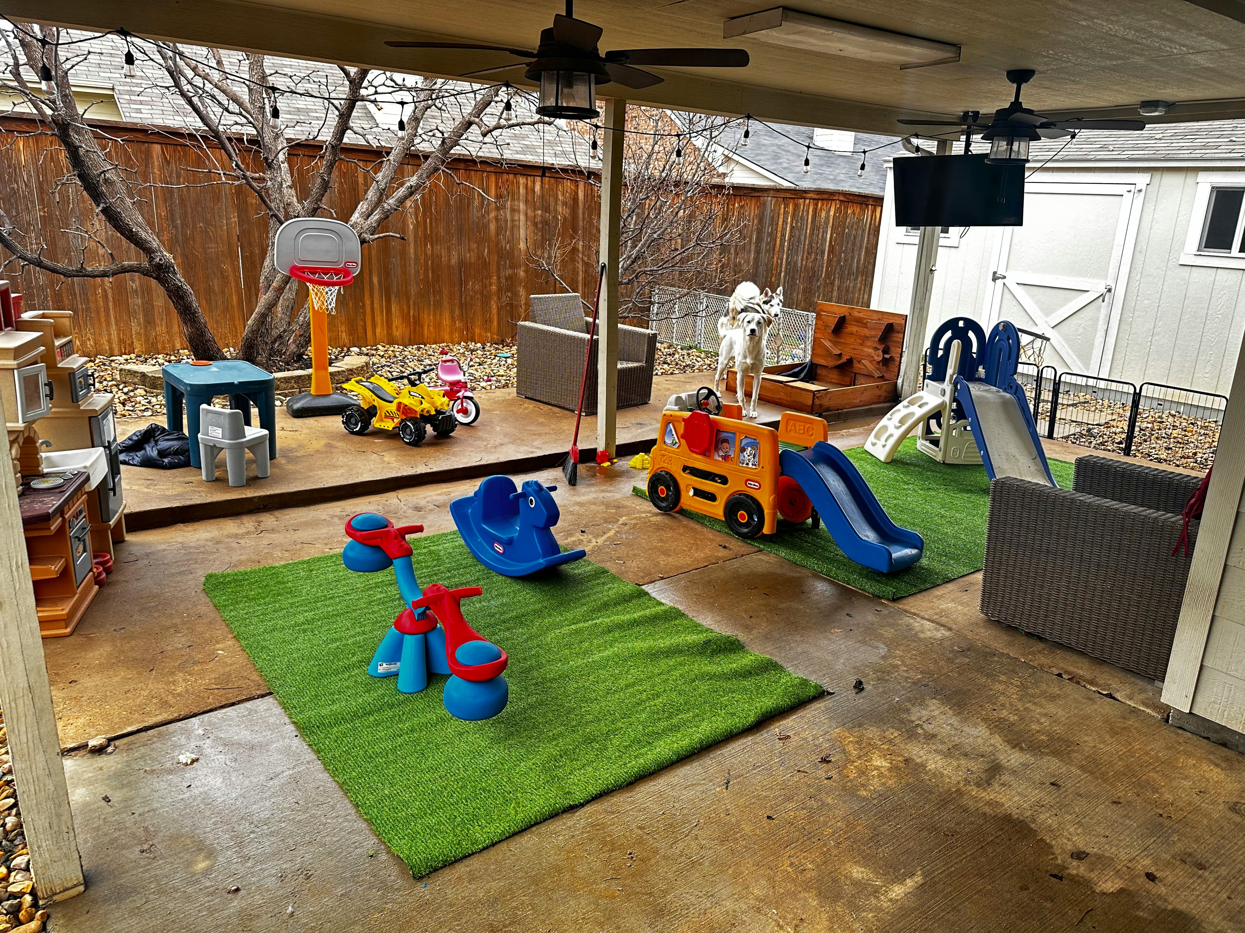 Outdoor patio with children's play equipment and artificial grass