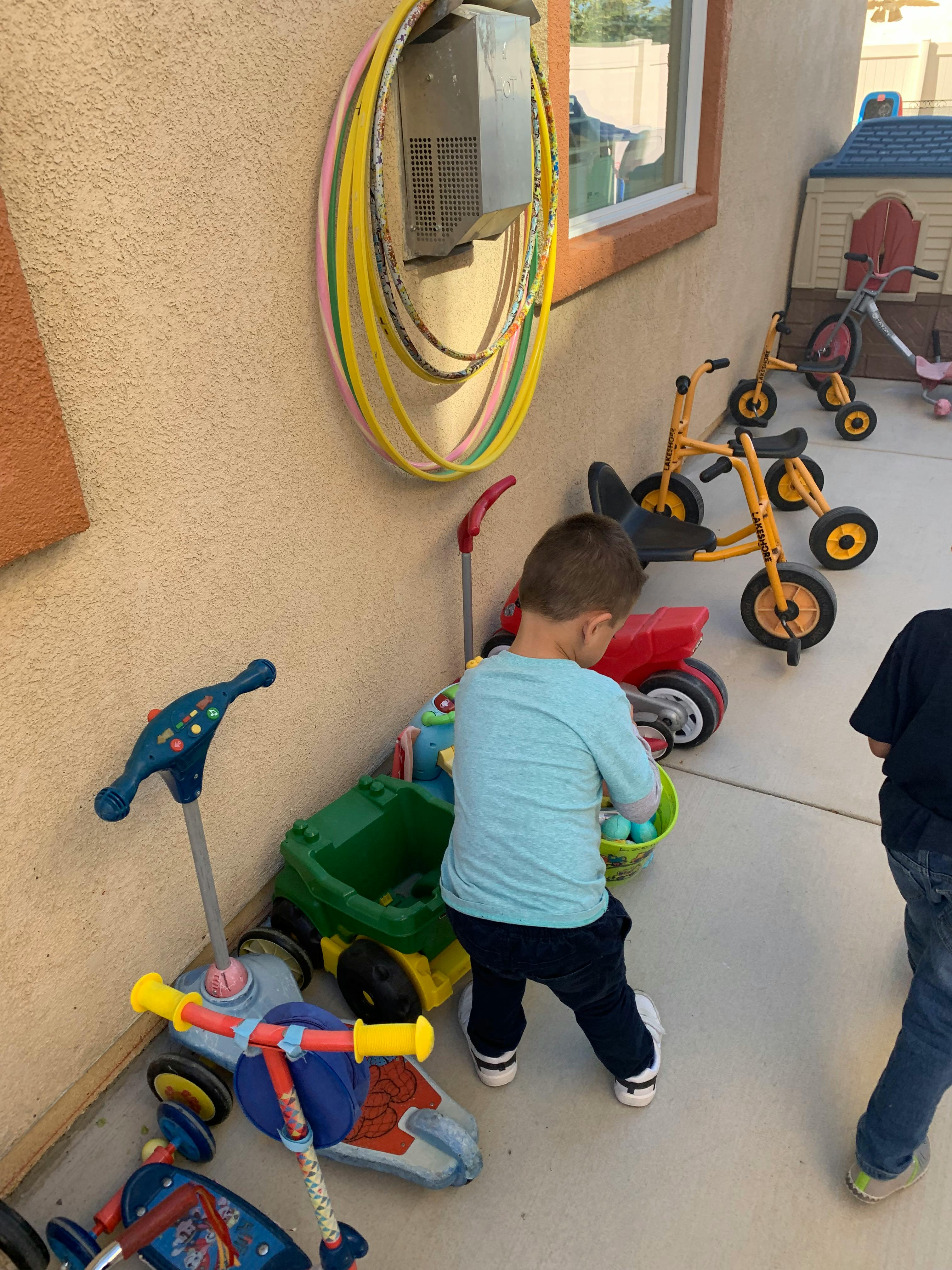 Child playing with toys on a patio