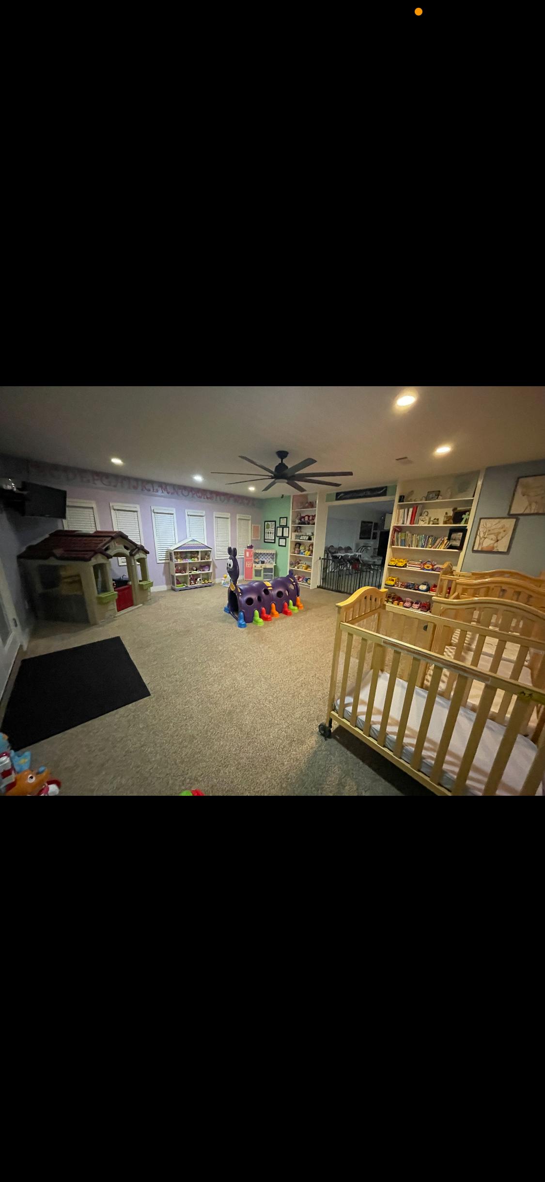 Playroom with cribs, playhouse, and caterpillar tunnel