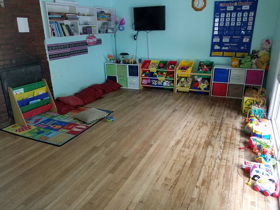 Playroom with toy storage, books, and a colorful rug