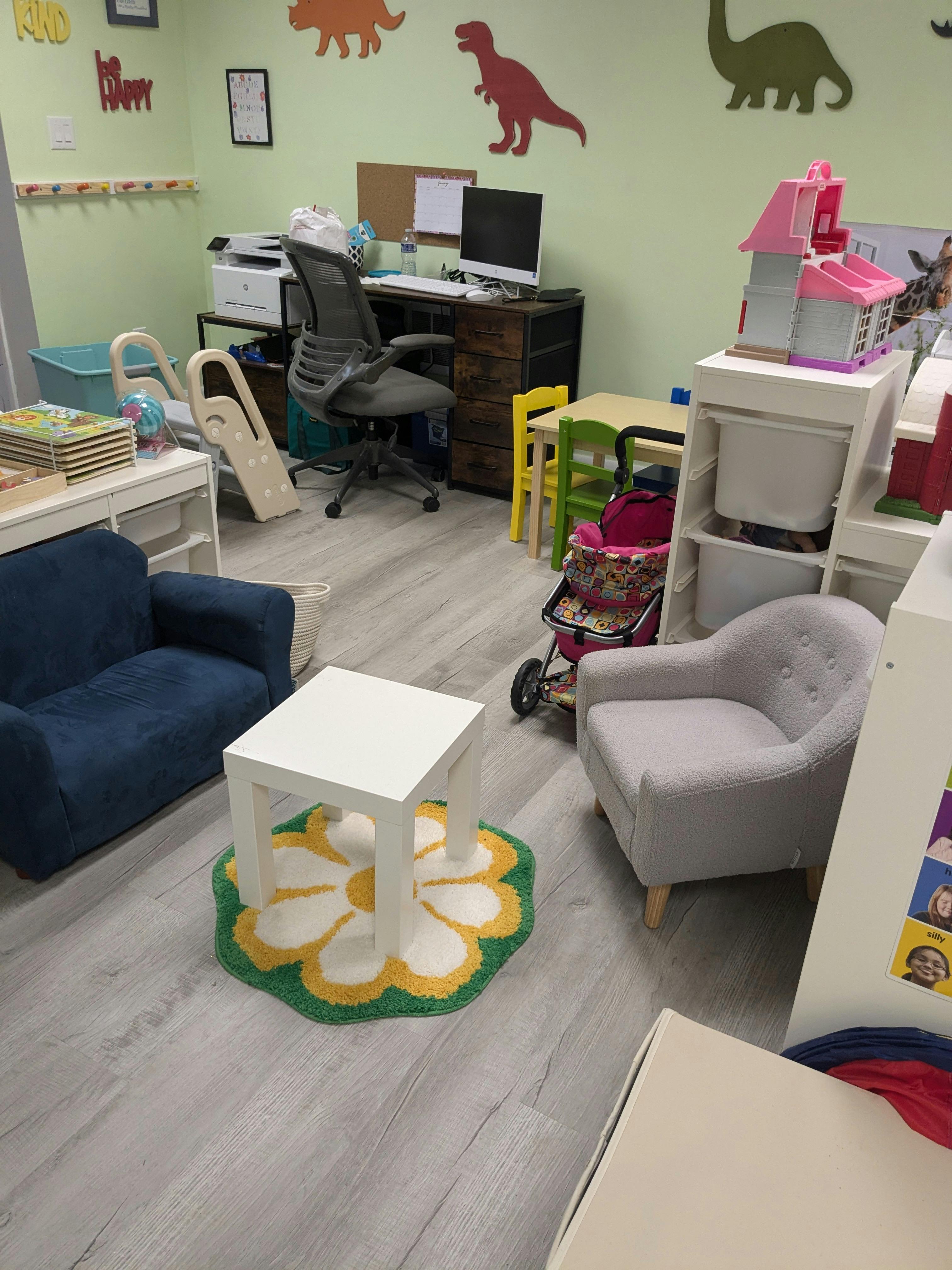 Playroom with a desk, chairs, and toys
