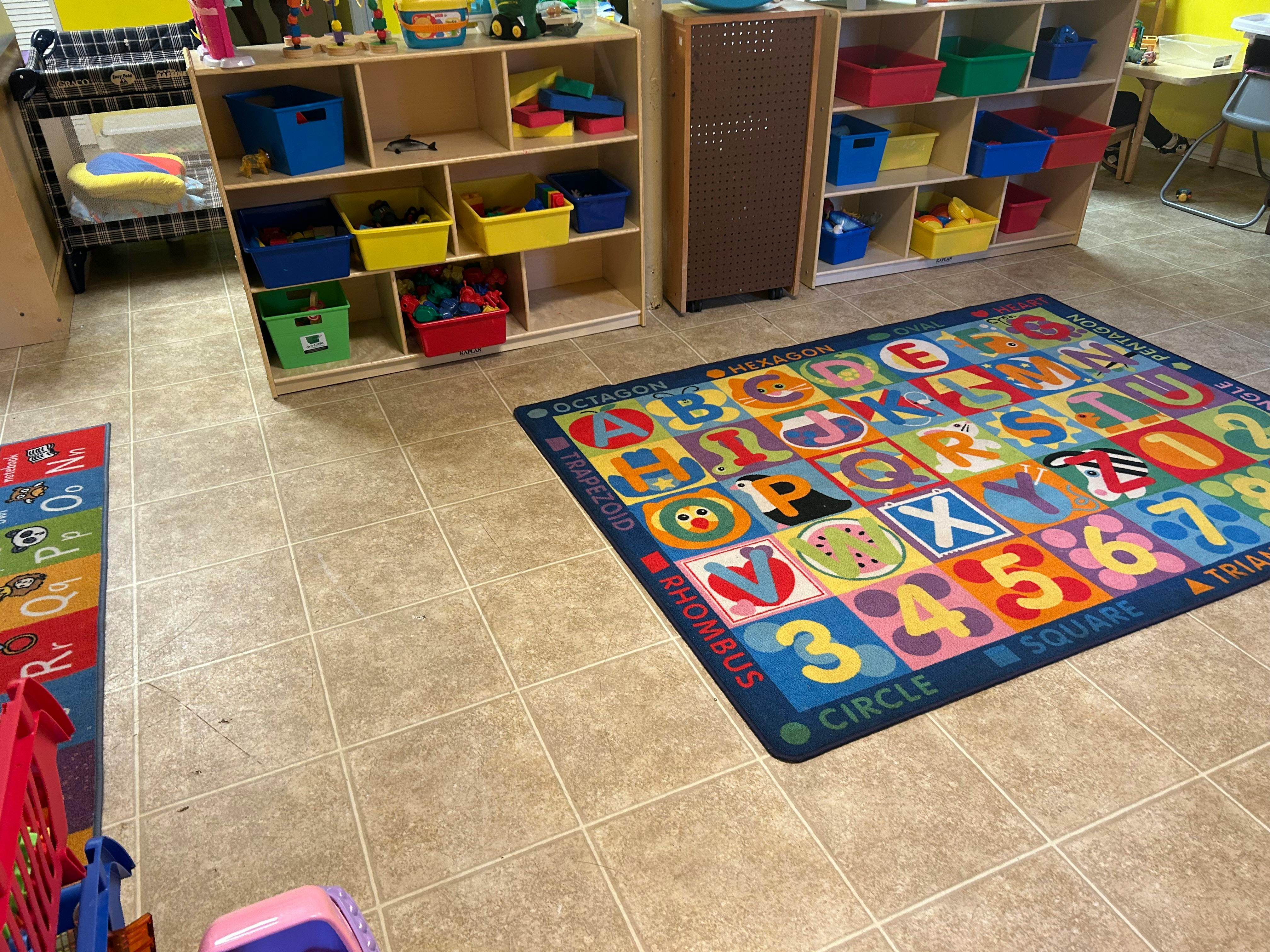 Classroom with alphabet rug and storage shelves