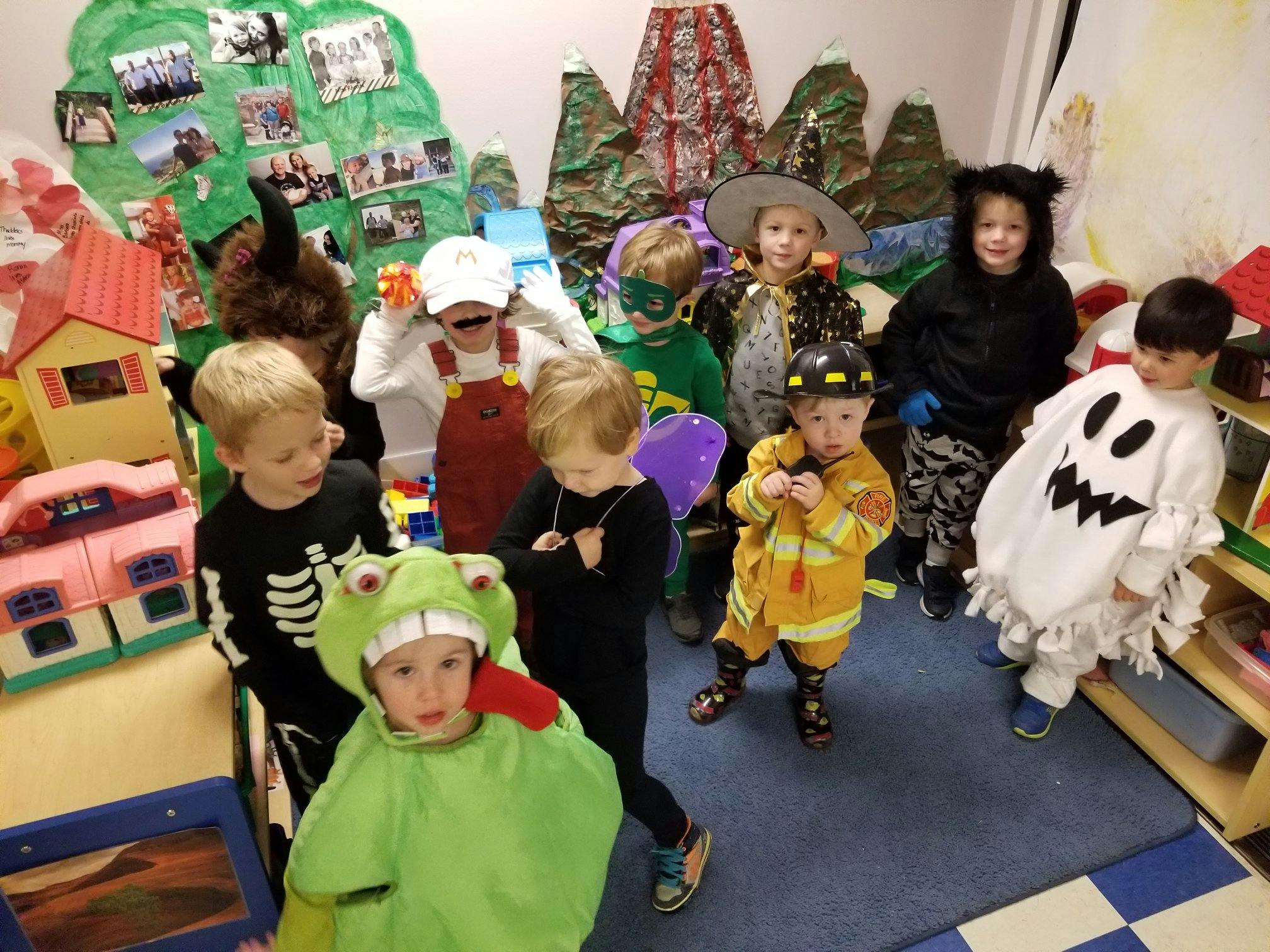 Children in various costumes standing together indoors