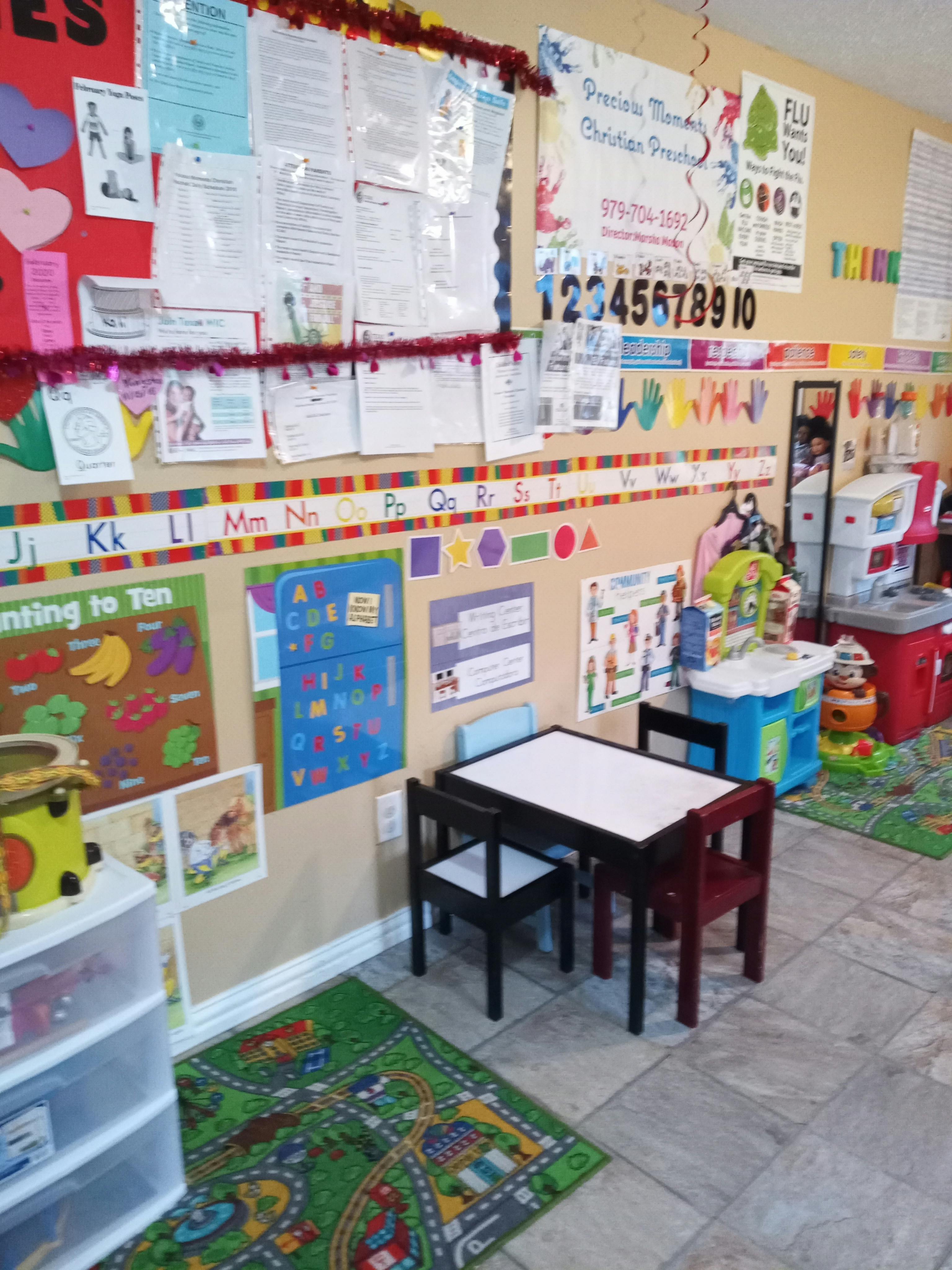 Classroom with small table and chairs, educational posters on walls