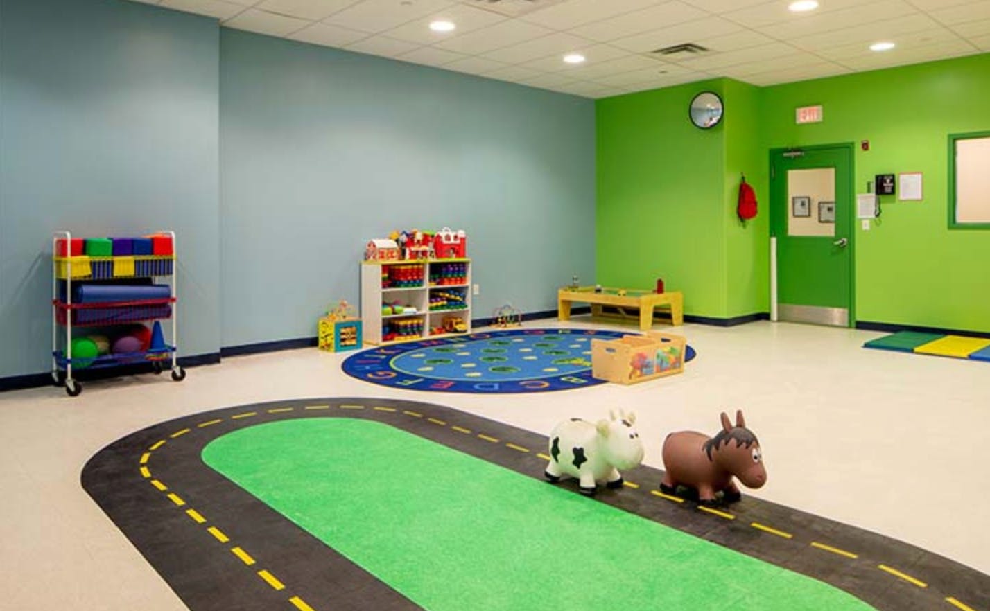 Playroom with road-patterned rug and toys