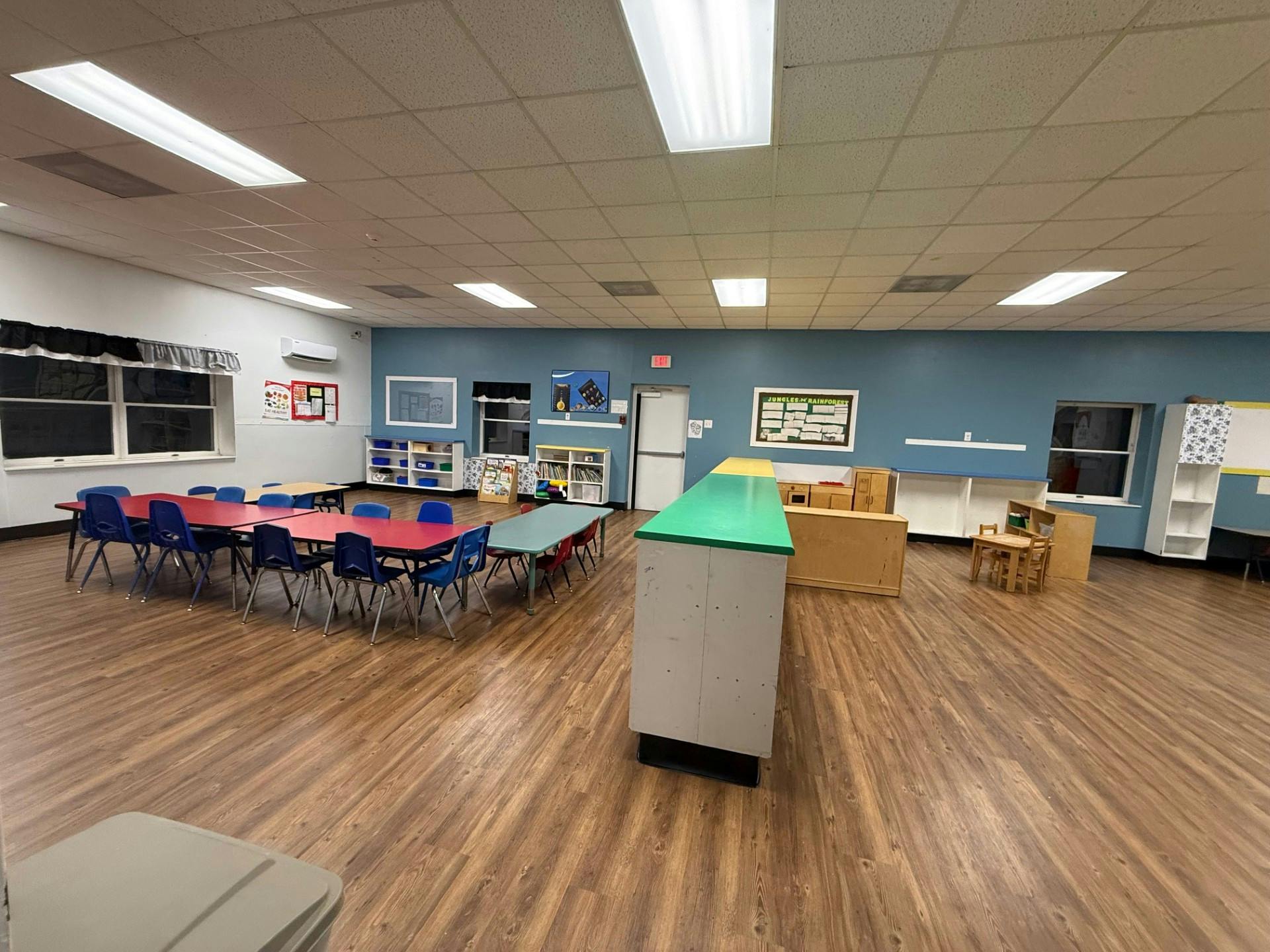 Classroom with blue and red tables and blue chairs