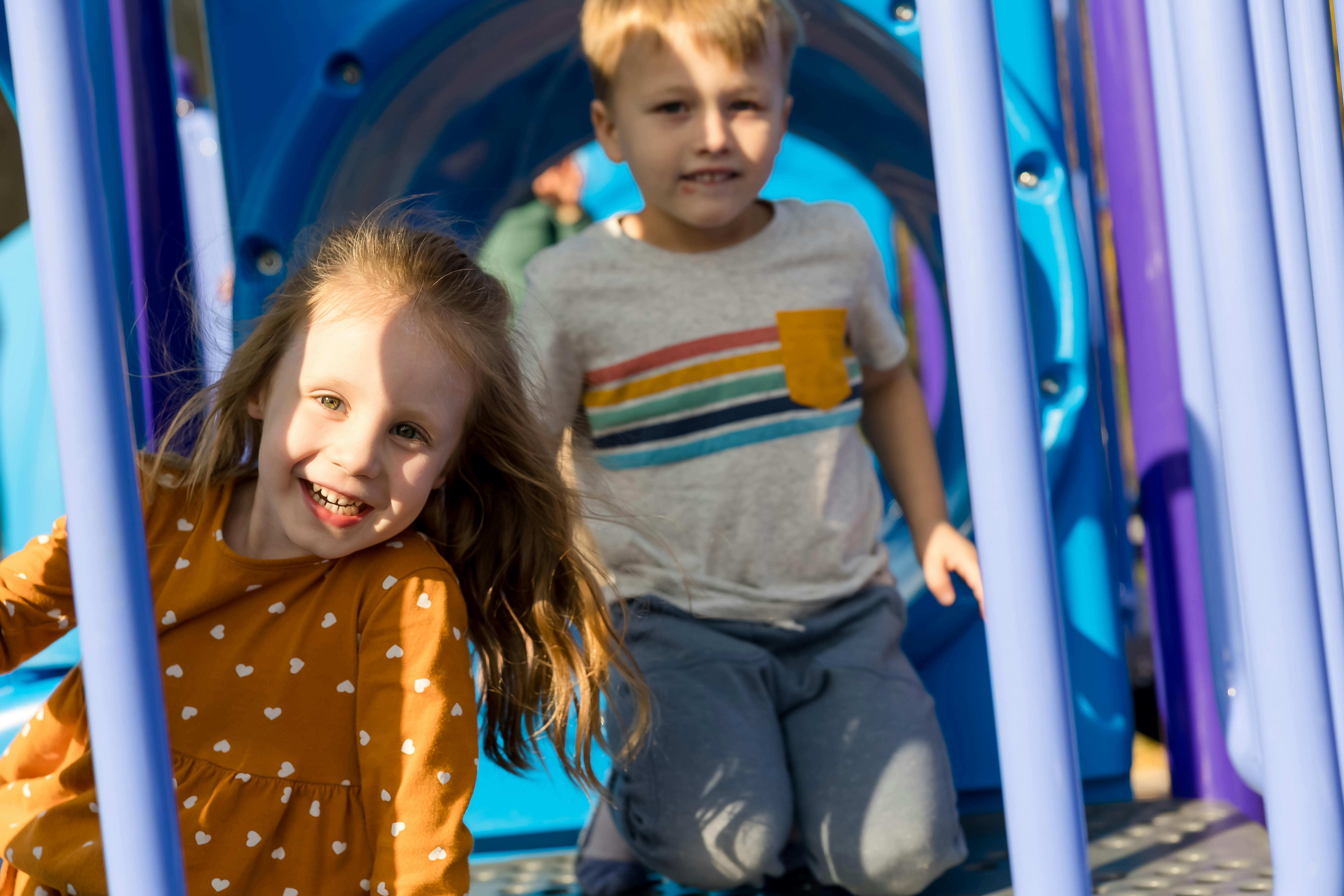 Two children on a playground structure