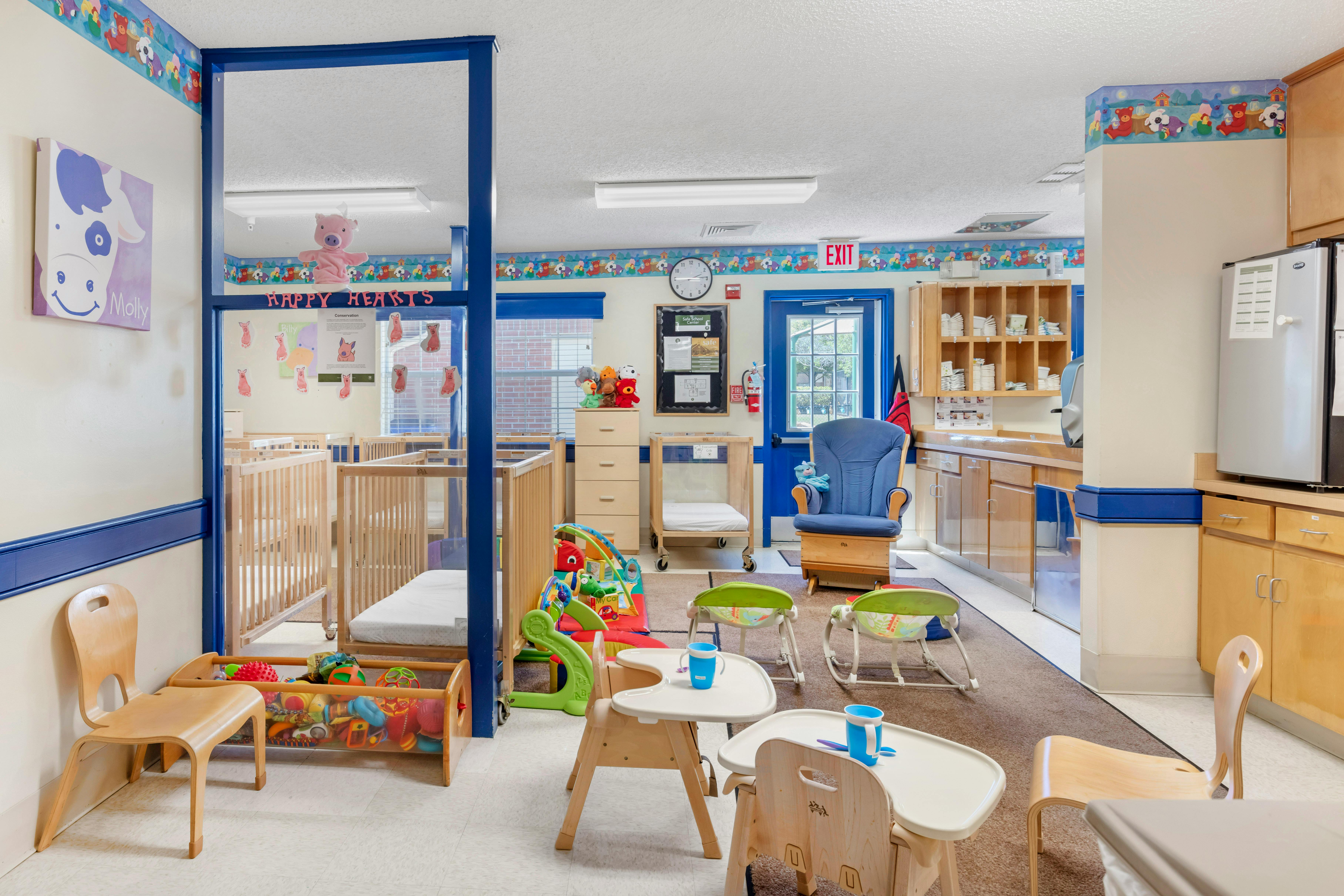 Cribs, chairs, and play items in a child's playroom