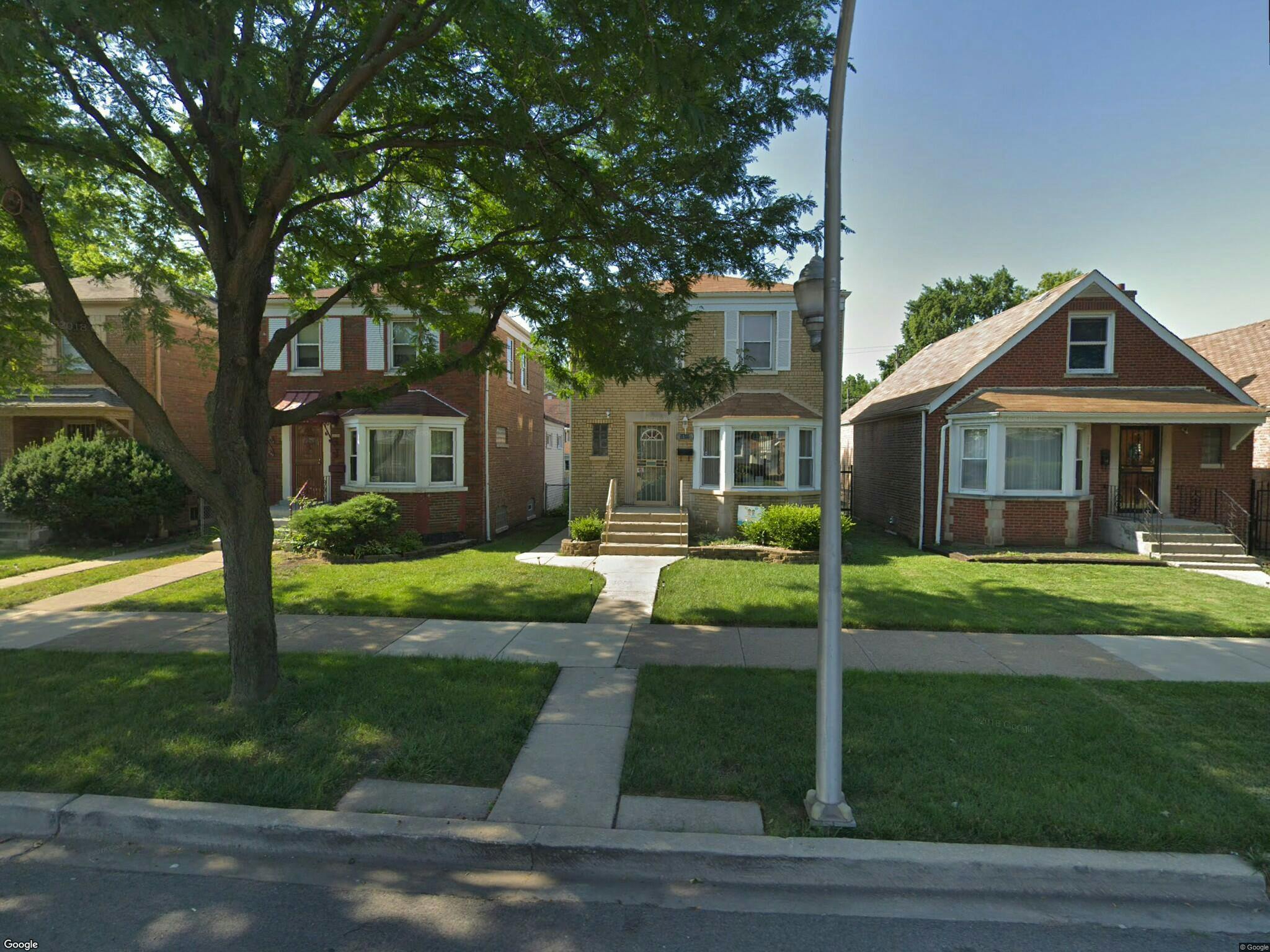 Row of houses with front yards and sidewalks