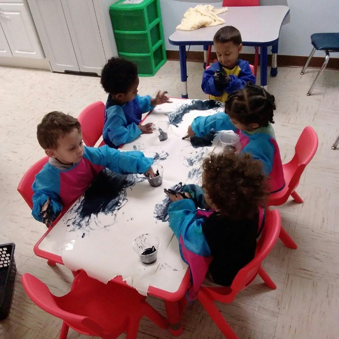 Children painting at a table
