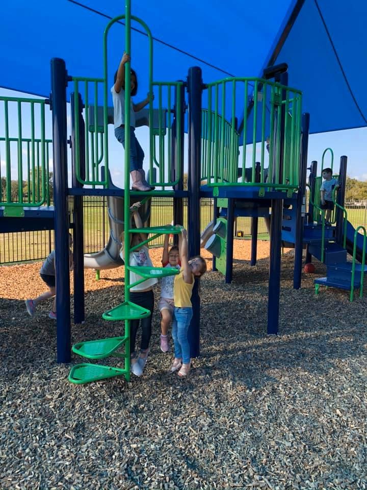Children playing on a playground structure