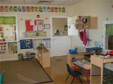 Empty classroom with small tables and chairs