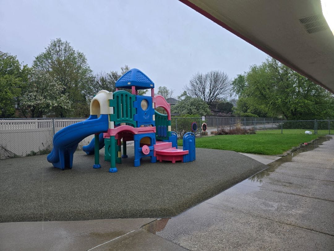 Colorful playground structure with slides on a soft surface