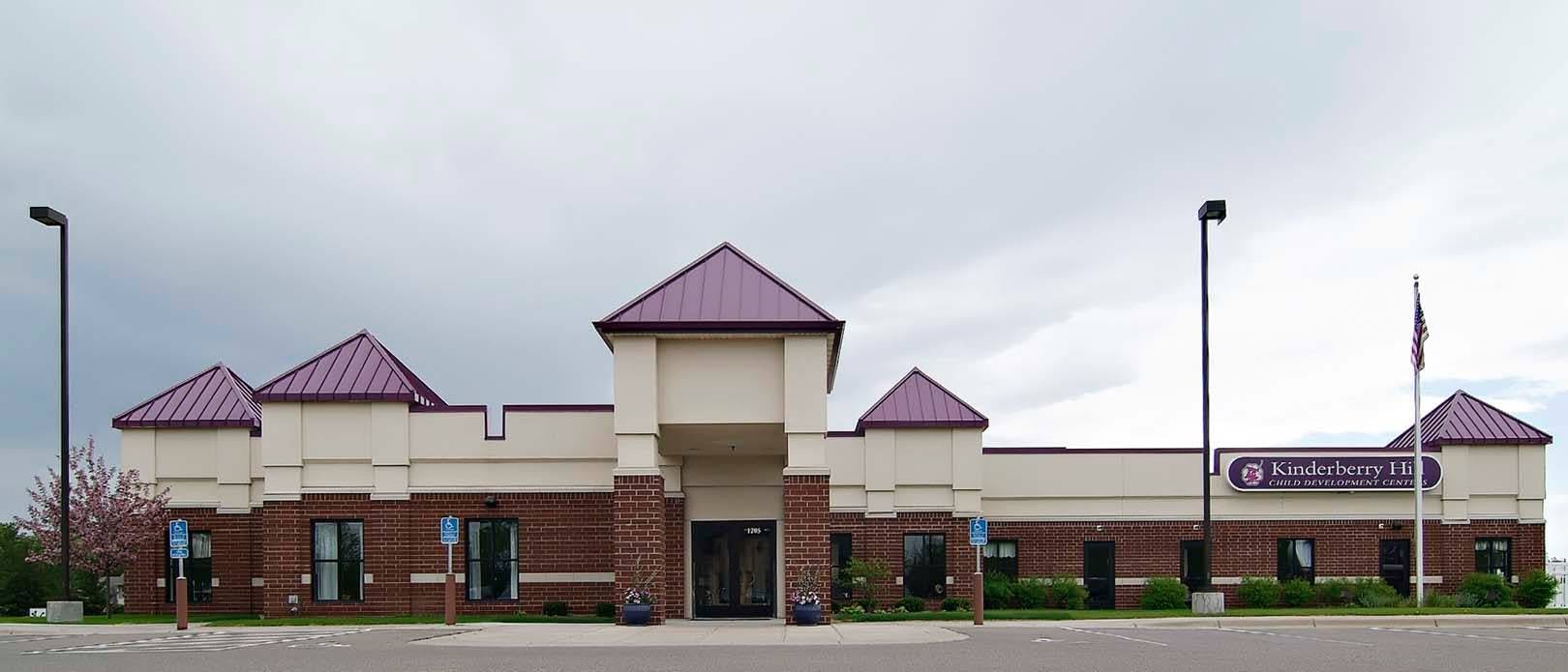 Building with purple roofs and a sign that says "Sandstone"