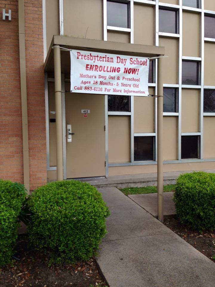 Presbyterian Day School enrolling now sign on a banner outside a building