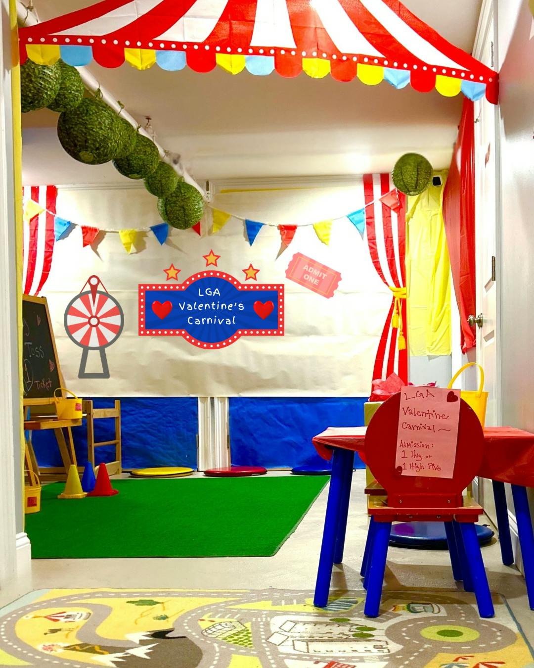 Indoor carnival setup with a sign reading "LGA Valentine's Carnival"