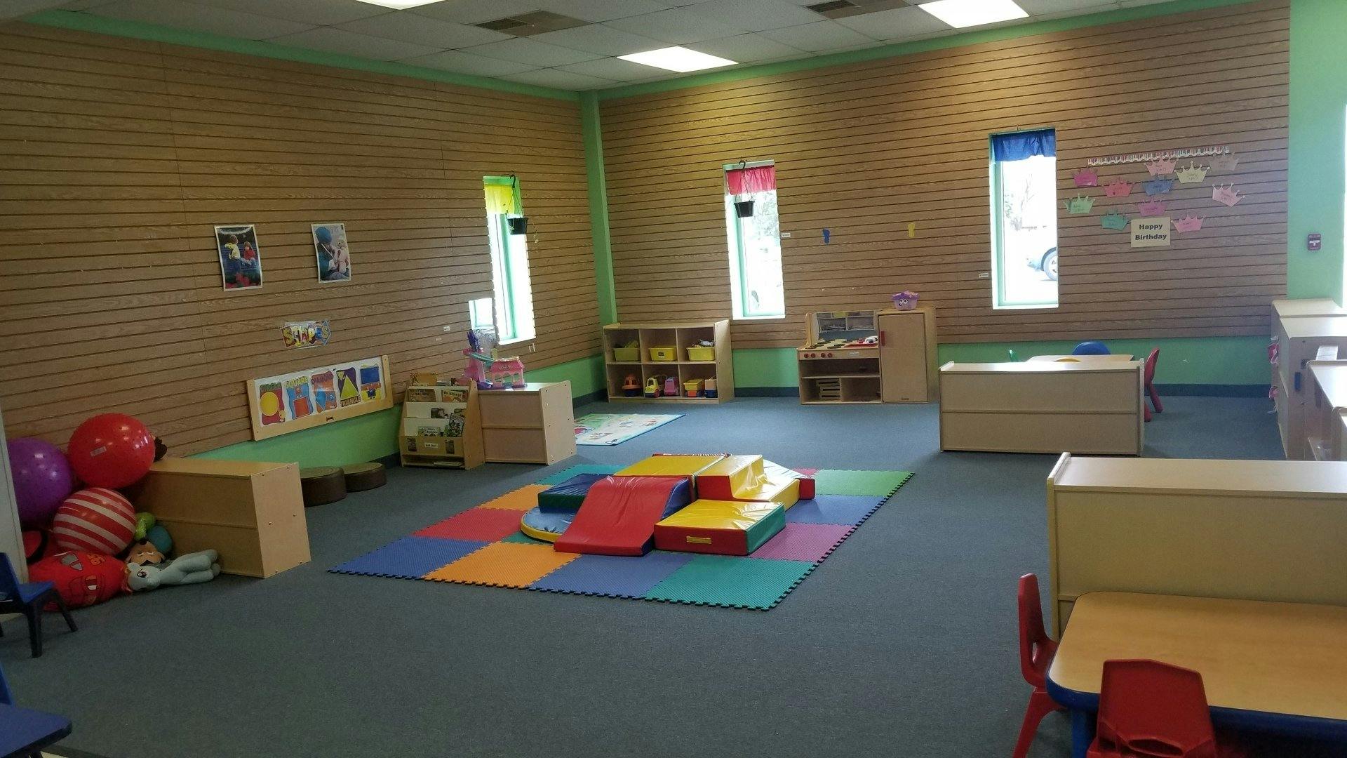 Playroom with colorful mats and soft play equipment