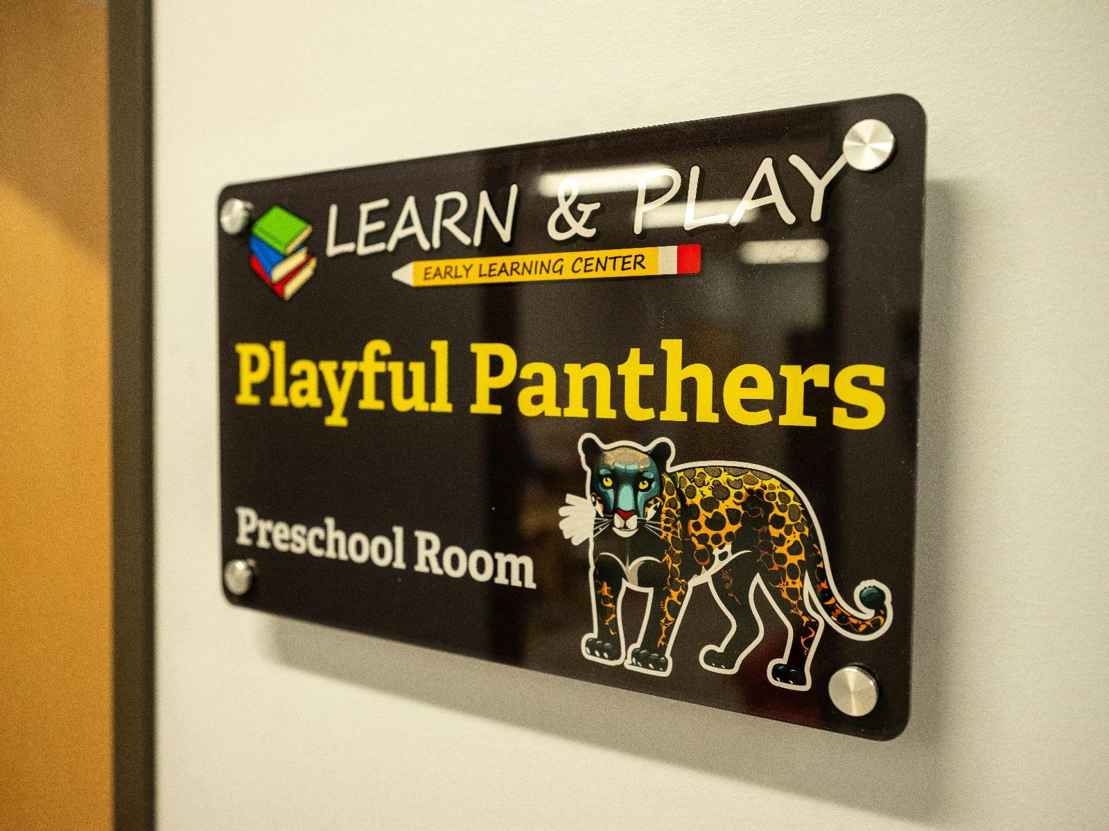Sign for "Learn & Play Early Learning Center Playful Panthers Preschool Room"