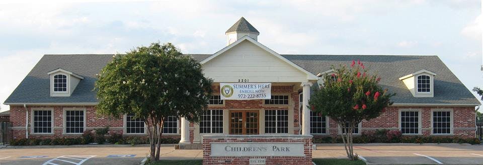 Brick building with white entrance and cupola
