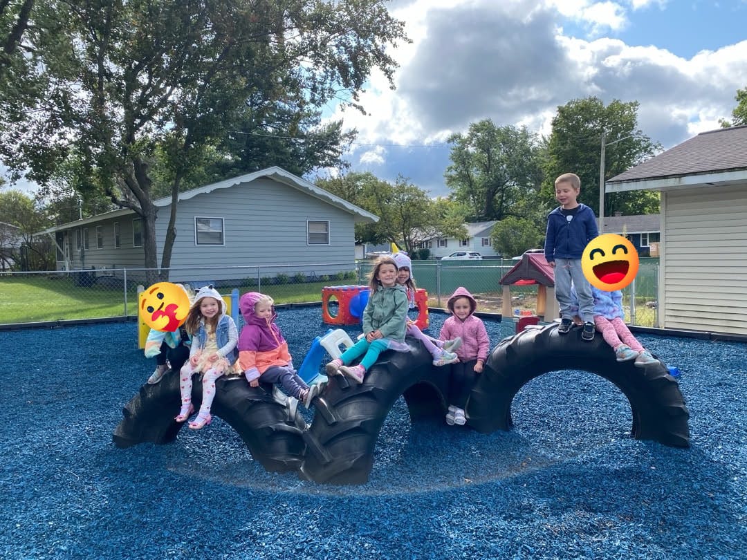 Children playing on tire structures on a playground