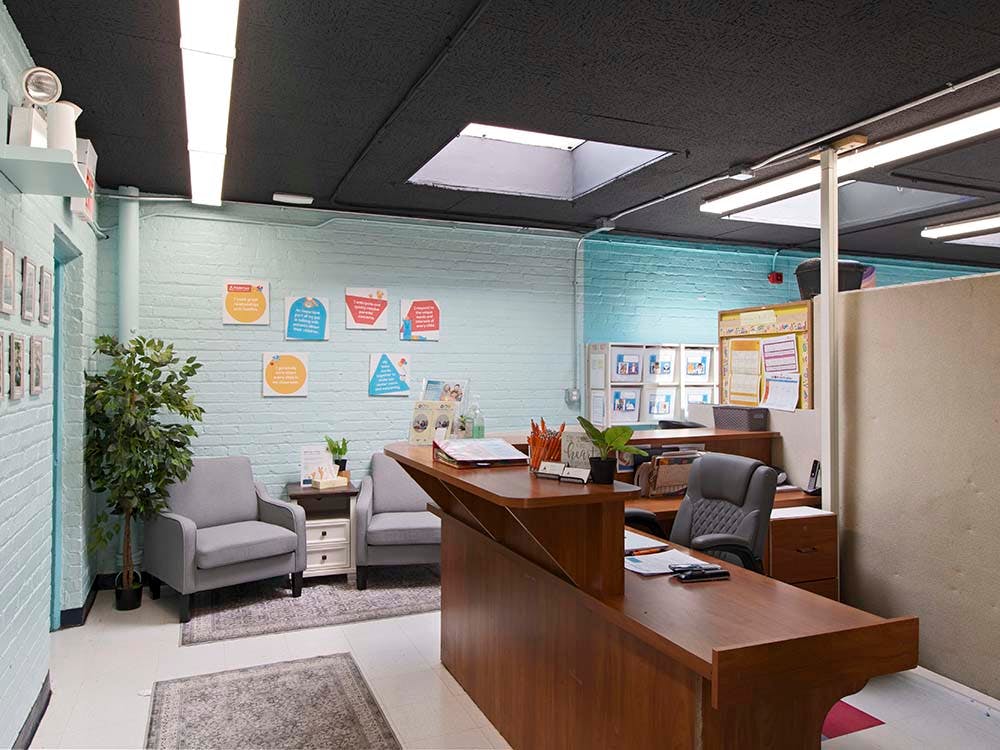 Reception desk with two chairs in a waiting area