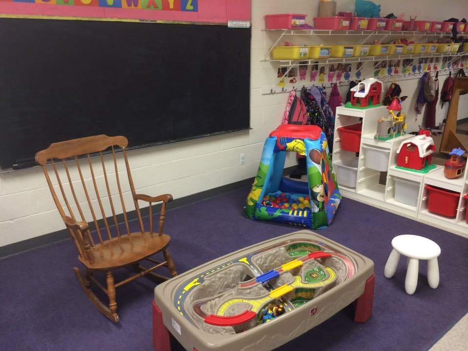 Classroom with a rocking chair, play tent, and toy table