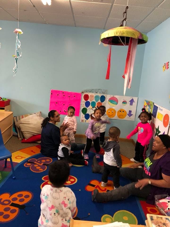 Adults and children in a classroom