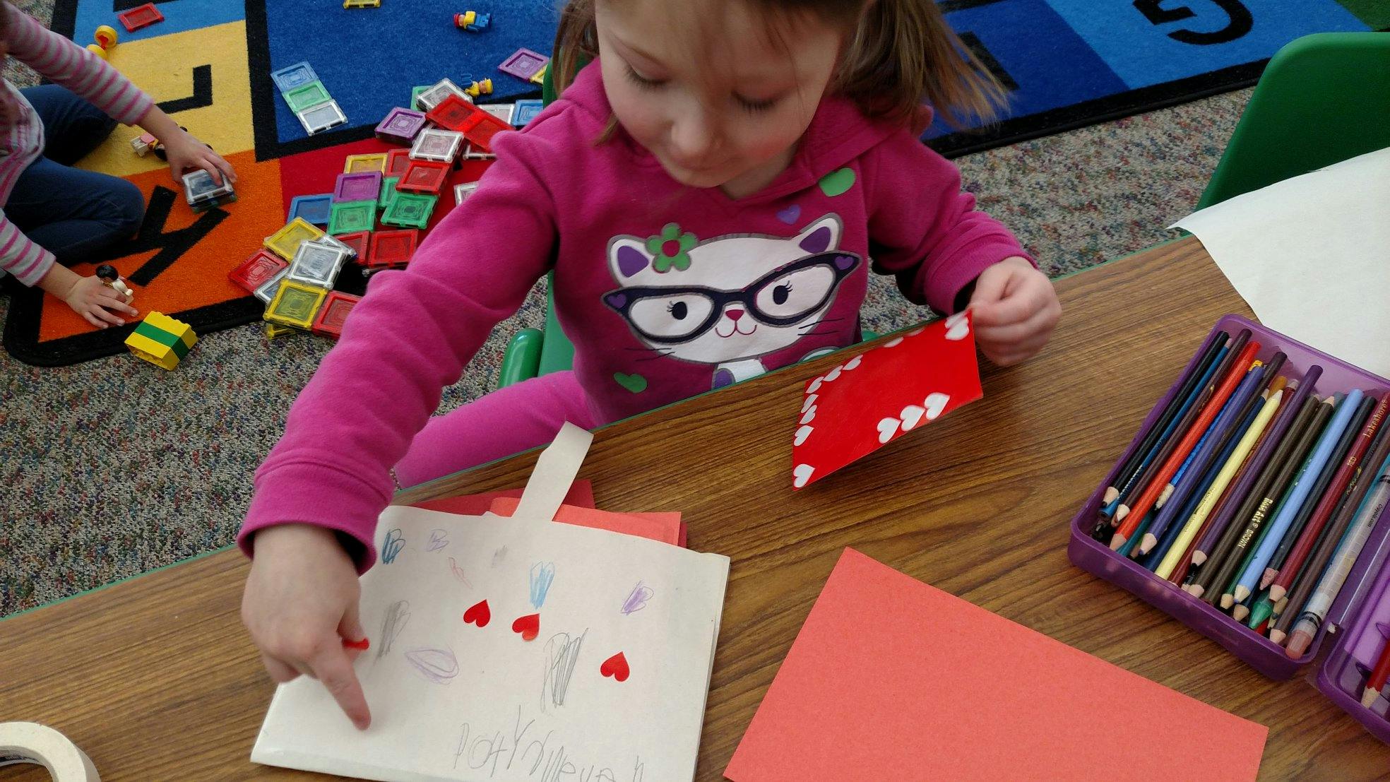 Child making crafts at a table