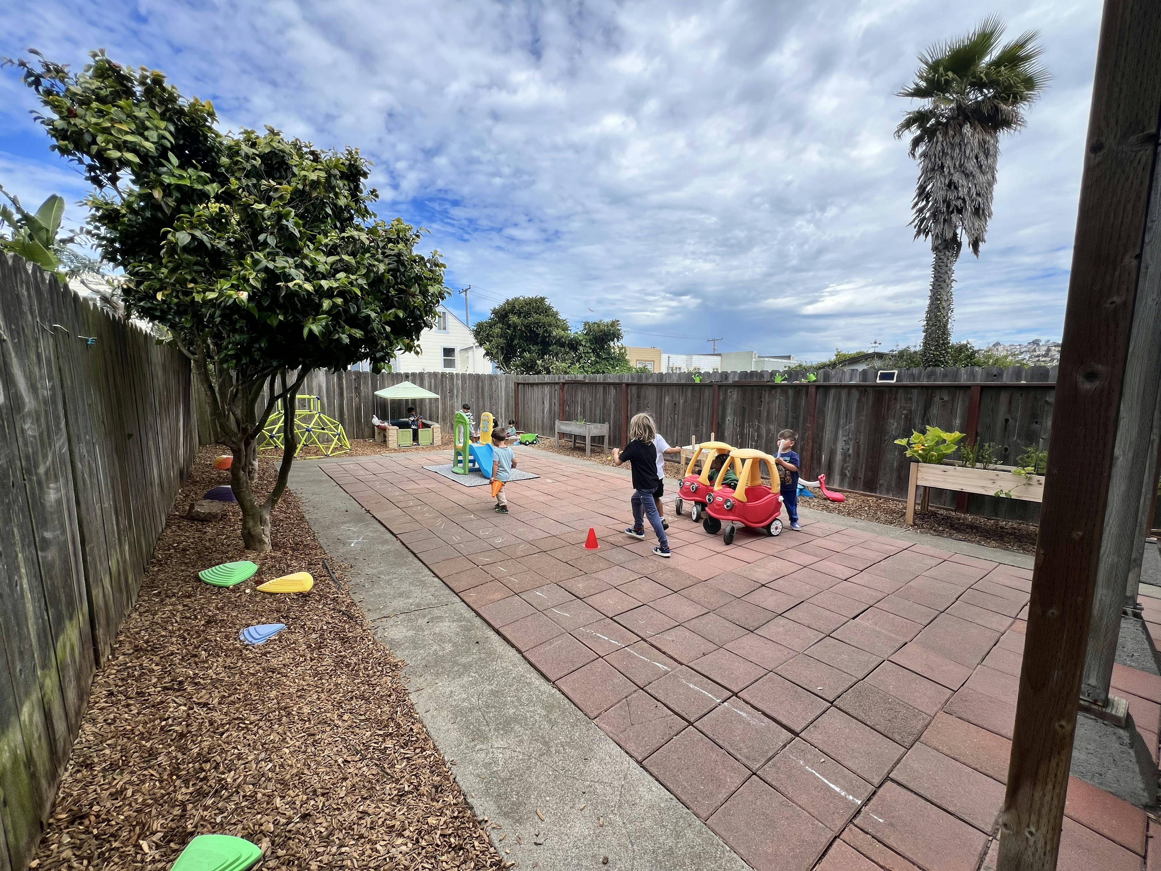 Children playing on a paved outdoor playground