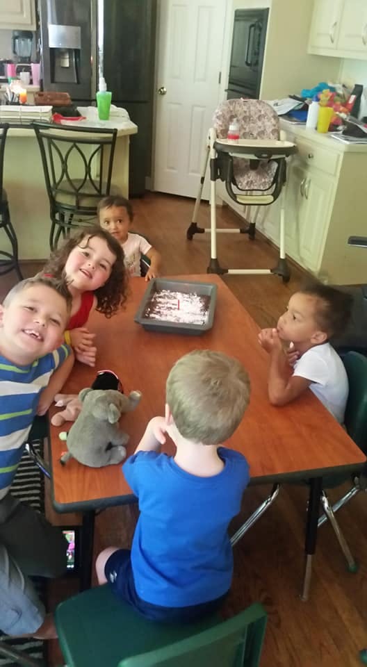 Children sitting around a table with a pan of brownies