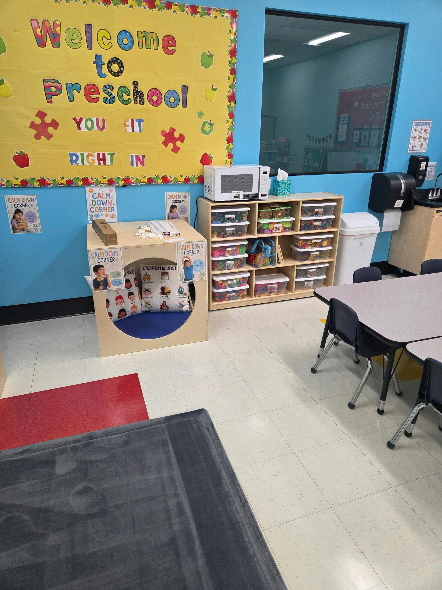 Preschool classroom with a calm down corner and organized storage bins