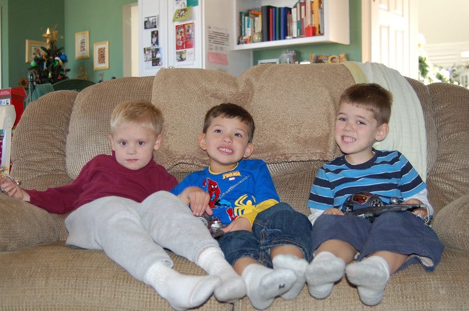 Three children sitting on a couch