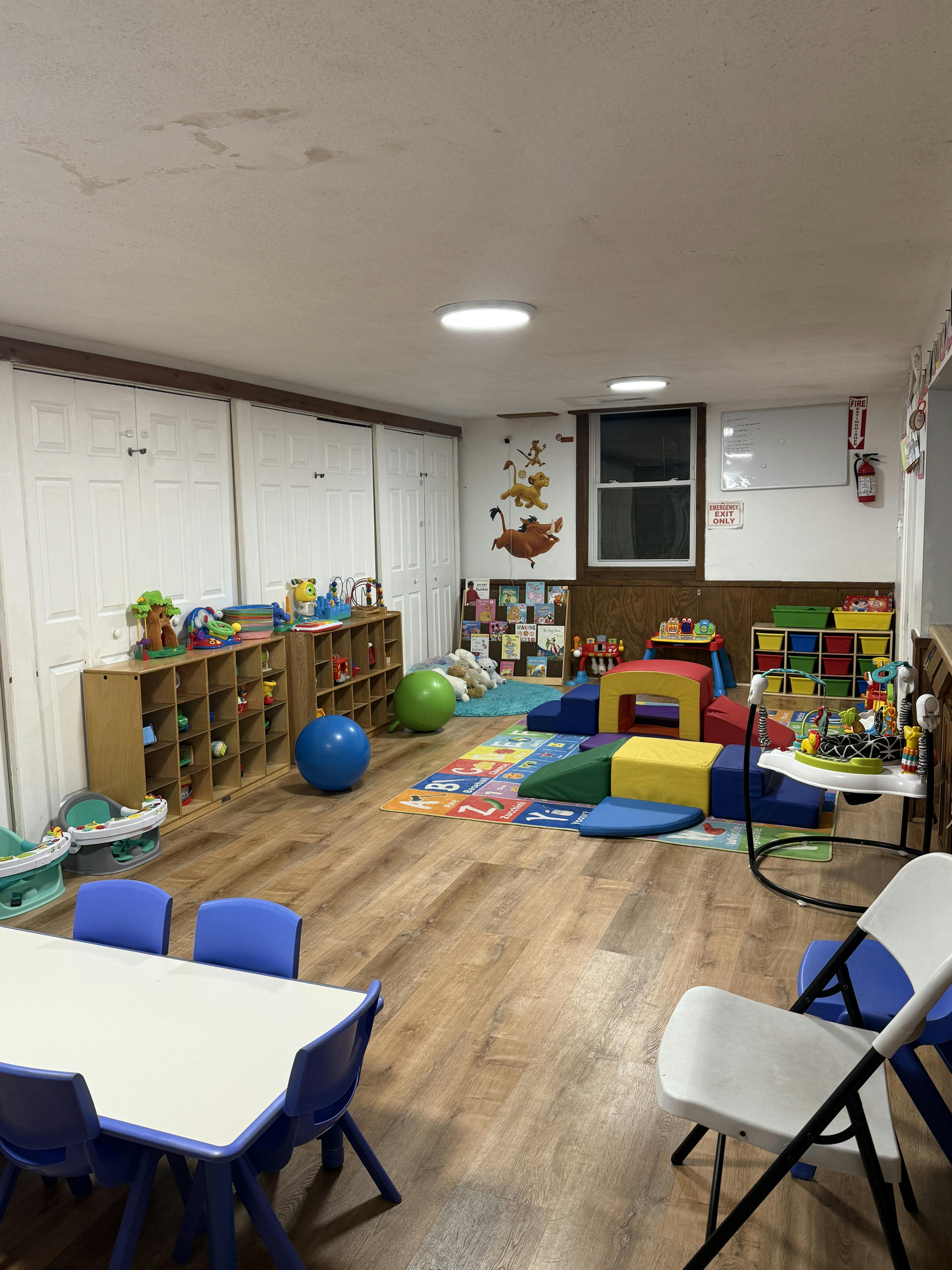 Playroom with children's toys, tables, and soft play equipment