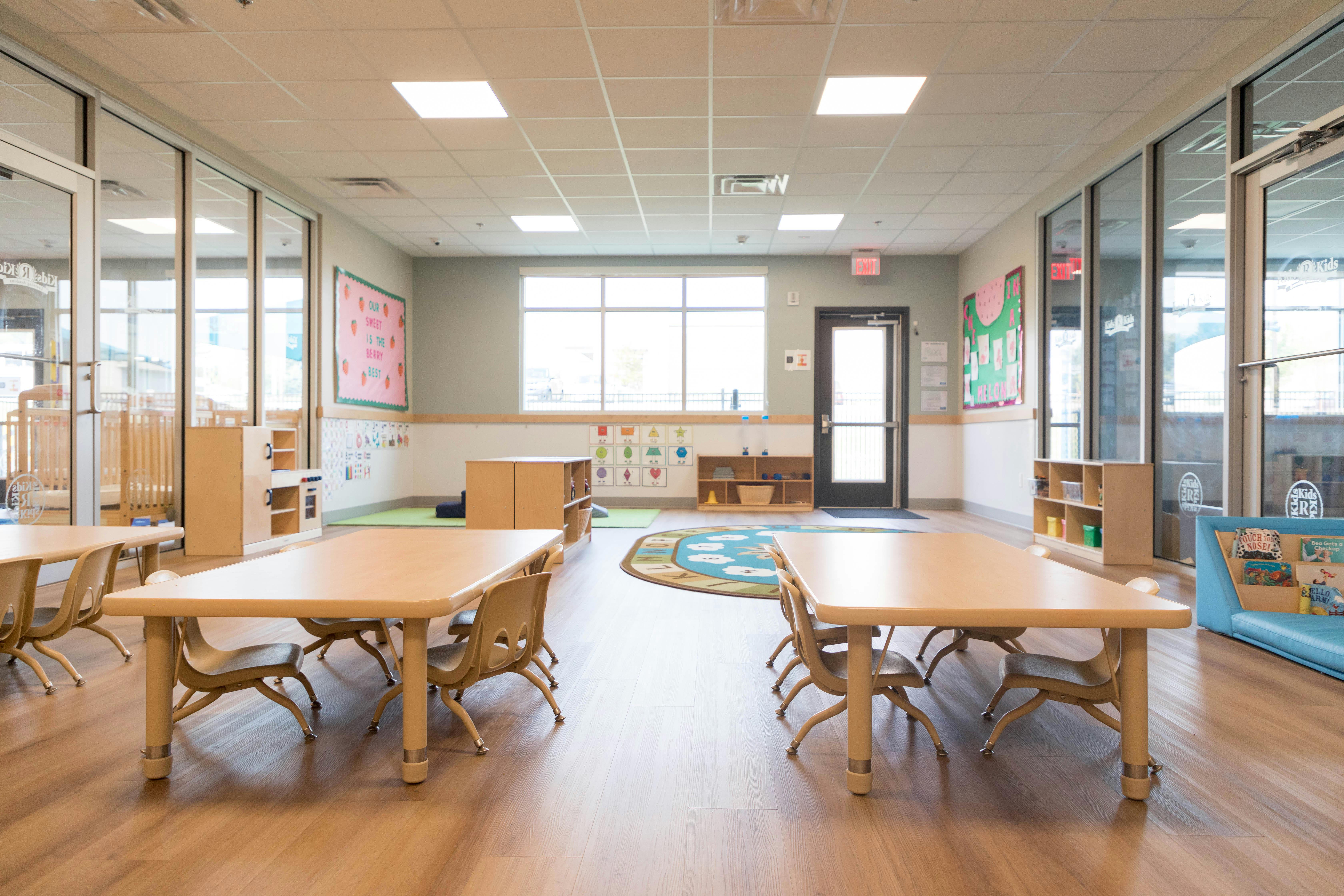 Empty classroom with small tables and chairs