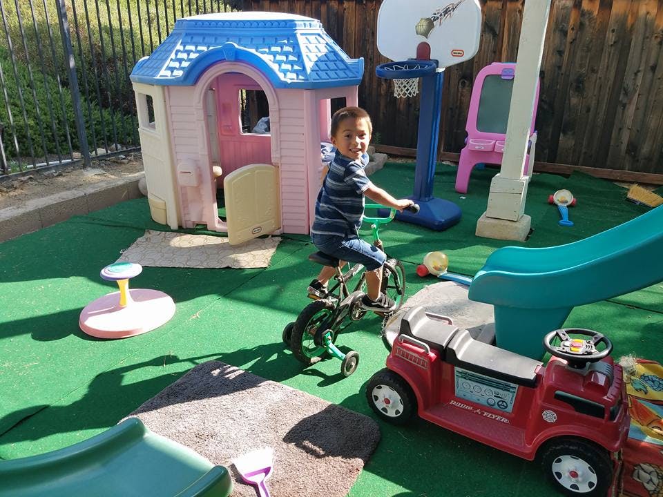 Child riding a bicycle in a play area